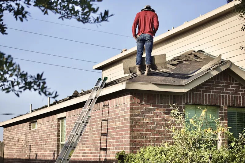 Professional roofer working on a residential roof in Woodmoor